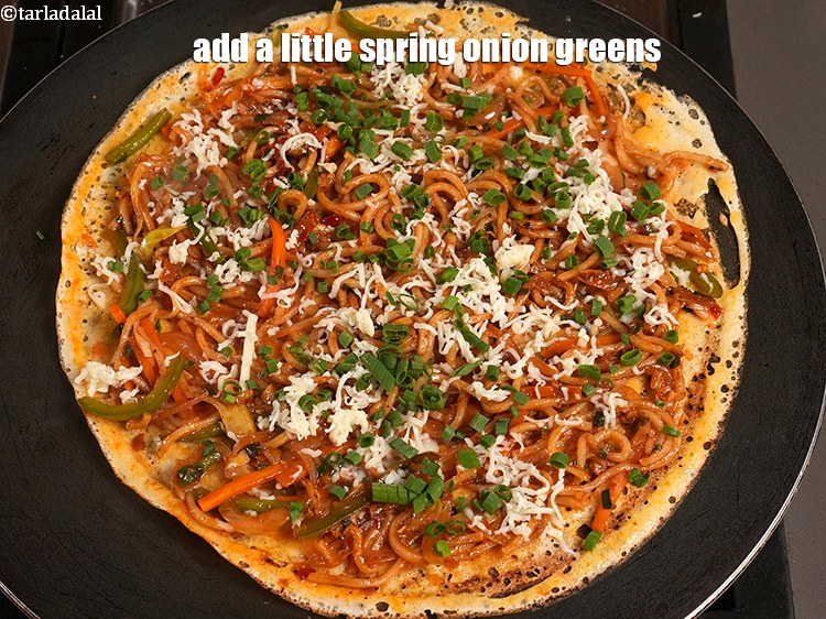 Step 35 – Add a little <a href="https://www.tarladalal.com/glossary-chopped-spring-onion-greens-1030i">chopped spring onion greens</a>&nbsp;.&nbsp;