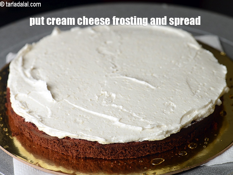 Step 39 – Put &frac12; cup cream cheese frosting and spread it evenly using a palette knife.