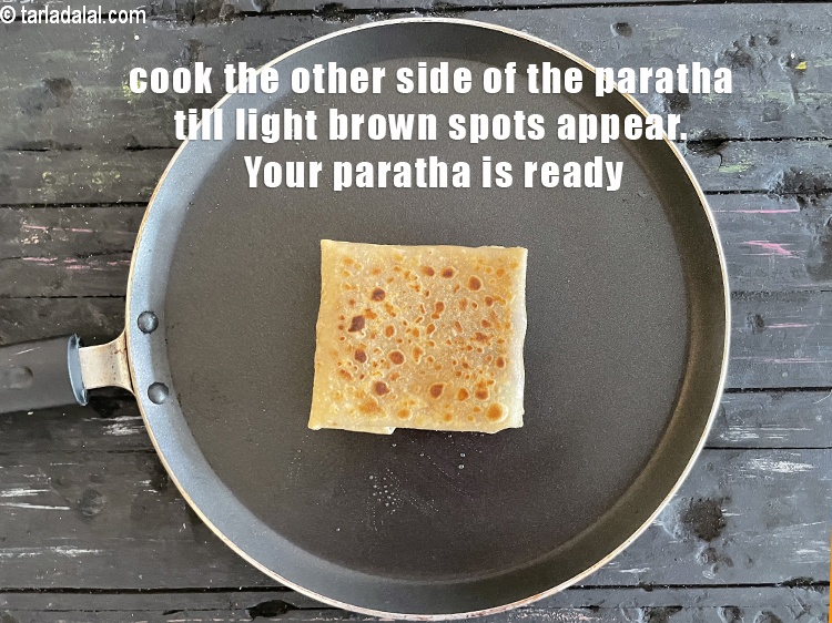 Step 54 – <meta charset="UTF-8" /> Cook the other&nbsp;side till light brown spots appear on the<strong>&nbsp;rajma paratha</strong>. Be …