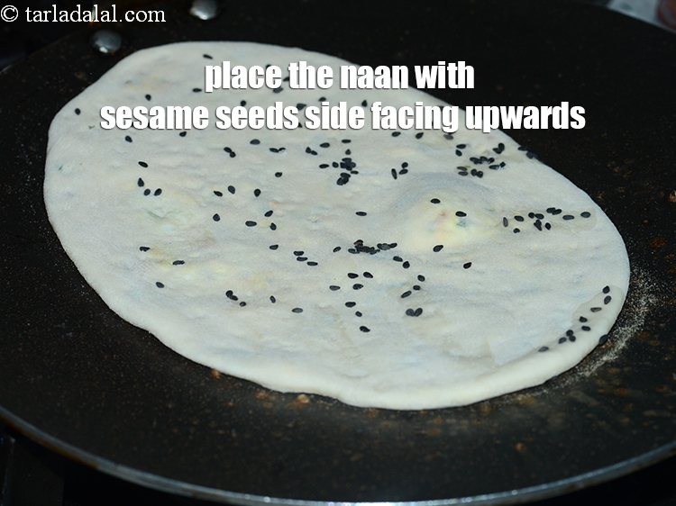 Step 38 – Place the naan on the tava sprinkled with salt water immediately with the naan with …