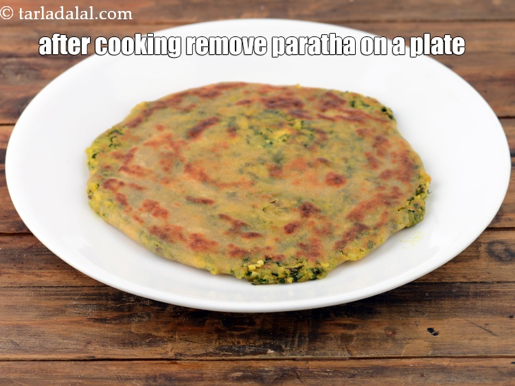 Step 36 – Once the<strong>&nbsp;</strong>paratha&nbsp;is cooked nicely on both sides, remove it on a plate.