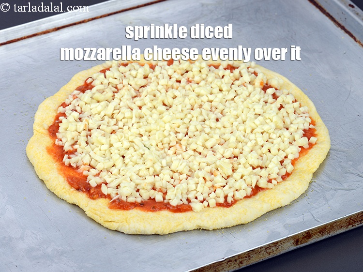 Step 35 – Sprinkle &frac34; cup diced&nbsp;<a href="https://www.tarladalal.com/glossary-mozzarella-cheese-311i">mozzarella cheese</a>&nbsp;evenly over it.