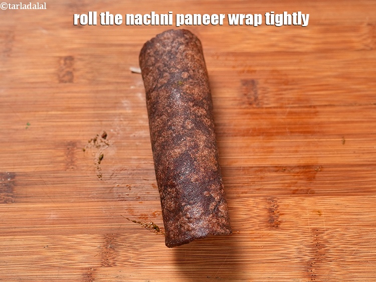 Step 34 – Roll the&nbsp;<strong>nachni paneer wrap </strong>tightly.