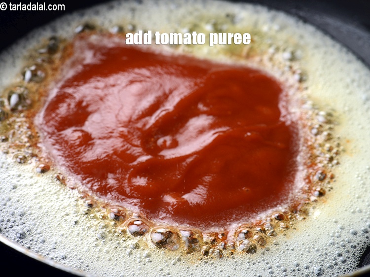 Step 35 – Add &frac14; cup tomato puree.