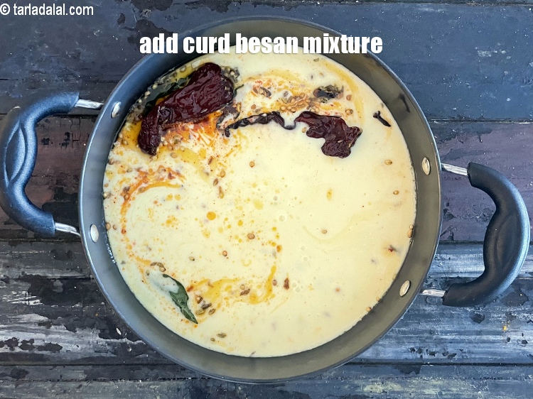 Step 37 – Add the curds-besan mixture.