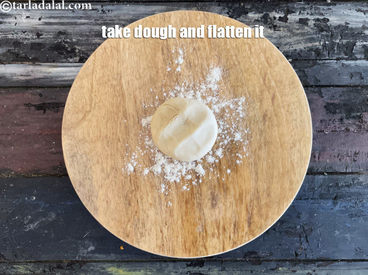 Step 34 – Take a portion of the dough and flatten it.