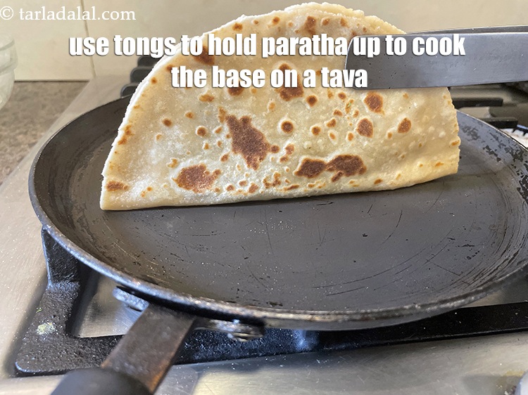 Step 38 – Remember that we need to cook the base of the paratha.&nbsp;&nbsp;So take a pair to …