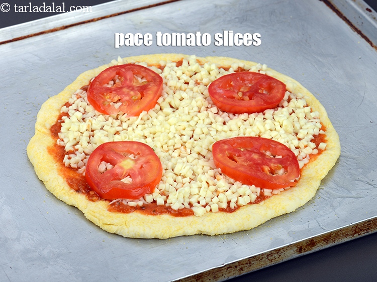 Step 36 – Place 4 <a href="https://www.tarladalal.com/glossary-tomato-slices-1823i">tomato slices</a>.