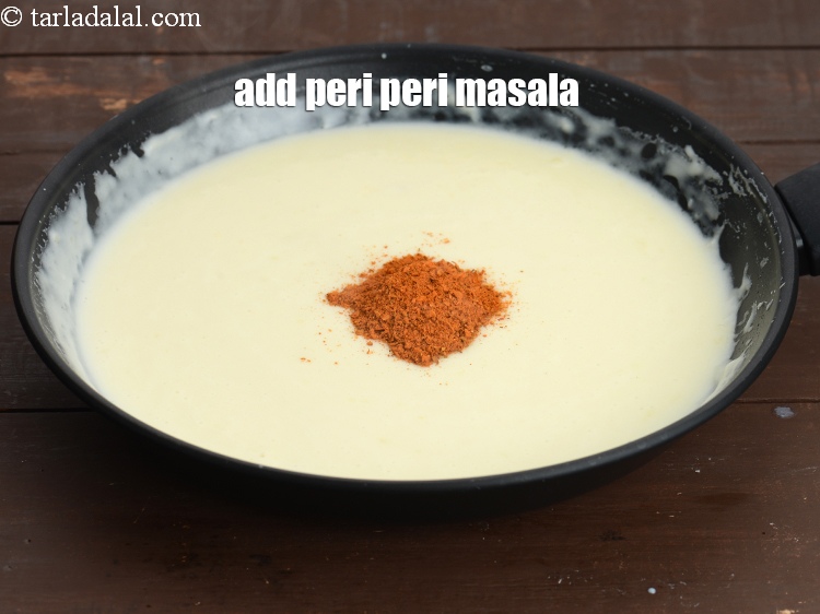 Step 39 – Add &frac12; tbsp <a href="https://www.tarladalal.com/peri-peri-masala-40207r">peri peri masala</a>.