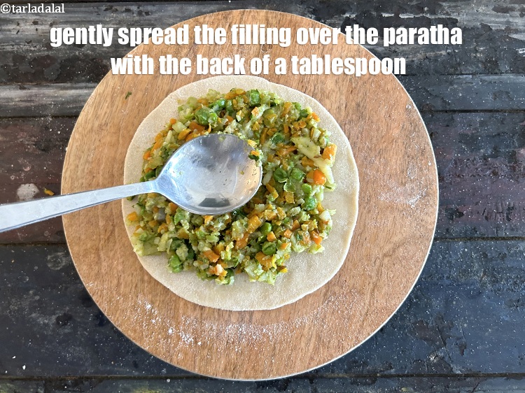 Step 36 – Gently spread the filling over the paratha with the back of a tablespoon.