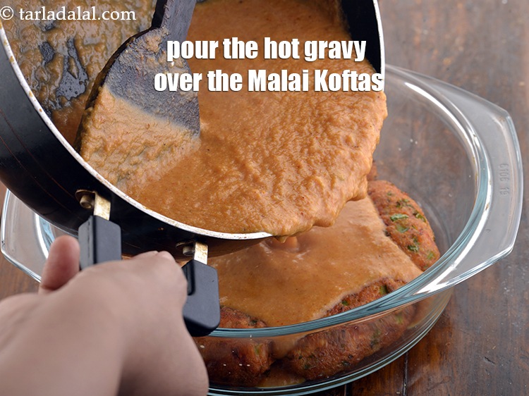 Step 35 – Pour the hot gravy over the&nbsp;<strong>Malai Koftas</strong>.