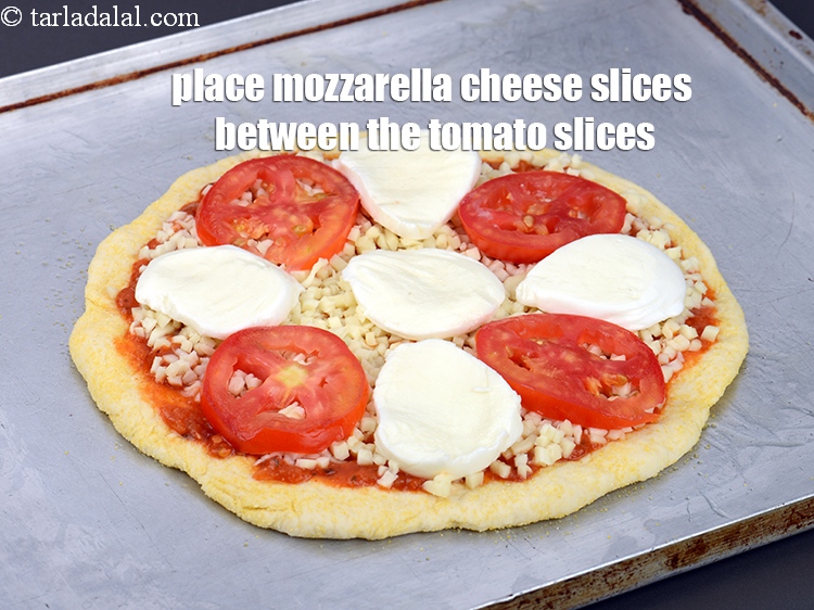 Step 37 – Place 5&nbsp;<a href="https://www.tarladalal.com/glossary-mozzarella-cheese-311i">mozzarella cheese</a>&nbsp;slices between the tomato slices.