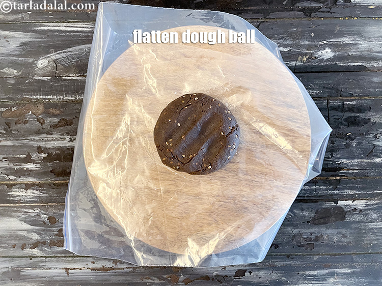 Step 46 – Flatten a dough ball and put a little ghee on top.