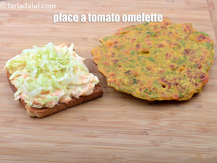 Step 38 – Place a&nbsp;tomato omelette on the 2nd toasted bread slice over the garlic chutney.