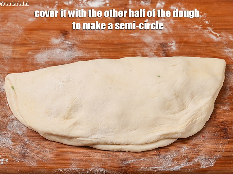 Step 39 – Cover it with the other half of the dough to make a semi-circle.
