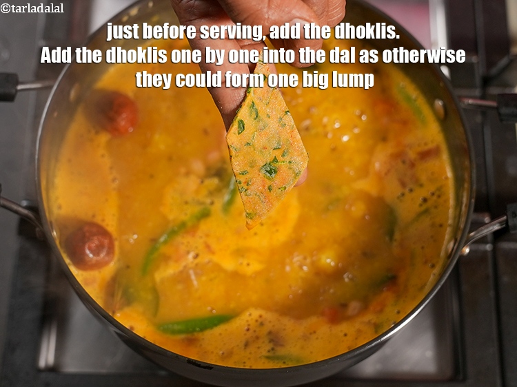 Step 38 – Just before serving, add the dhoklis. Add the dhoklis one by one into the dal …