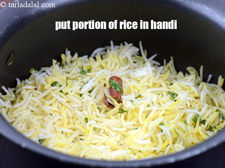Step 43 – Put a portion of the rice in a handi.