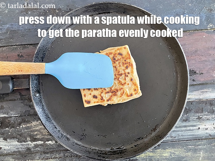 Step 40 – Remember to press down with a spatual while cooking the paratha.