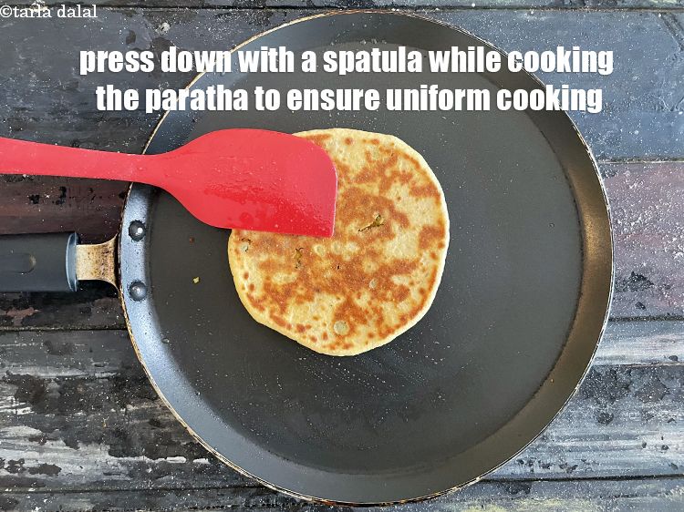 Step 54 – Press down with a spatula while cooking the paratha to ensure uniform cooking.