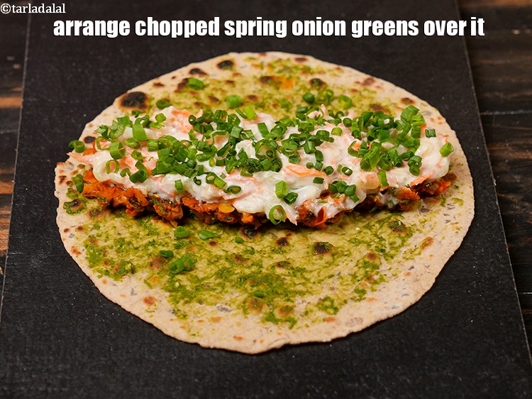 Step 39 – Arrange 1 tbsp of <a href="https://www.tarladalal.com/glossary-chopped-spring-onion-greens-1030i">chopped spring onion greens</a>&nbsp;over it.