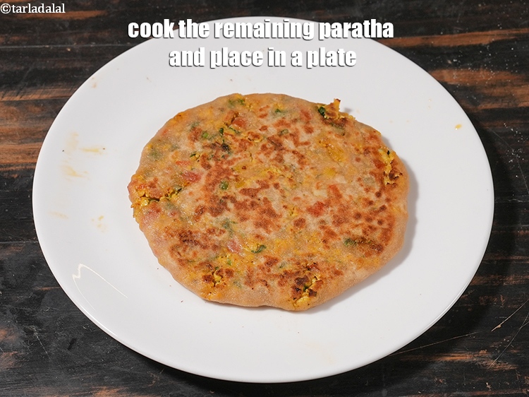 Step 47 – <meta charset="UTF-8" /> Cook the remaining<strong>&nbsp;paratha&nbsp;</strong>and place in a plate.&nbsp;