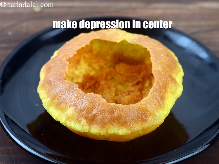 Step 42 – Make a depression in the center of the kachori.