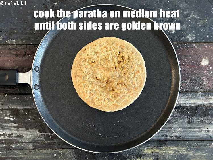 Step 46 – <meta charset="UTF-8" />Cook the paratha on medium heat until both sides are golden brown.&nbsp;<br /> …