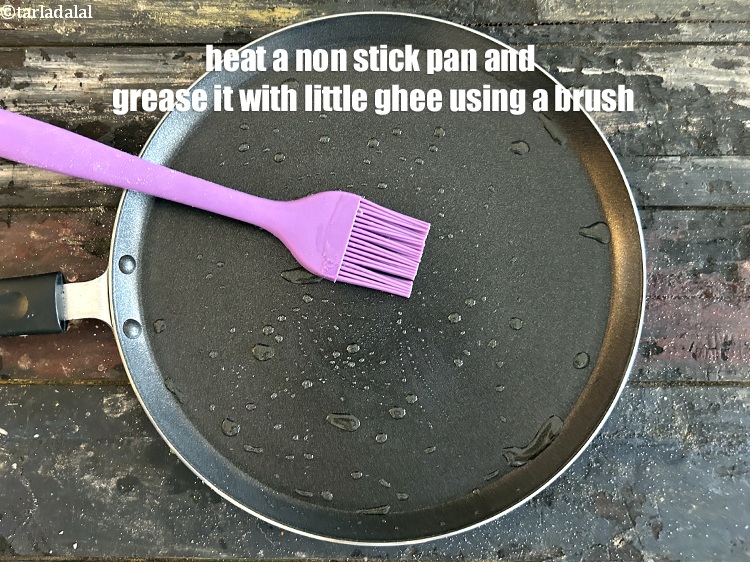 Step 40 – Heat a non-stick tava (griddle) and grease it with ghee using a brush.