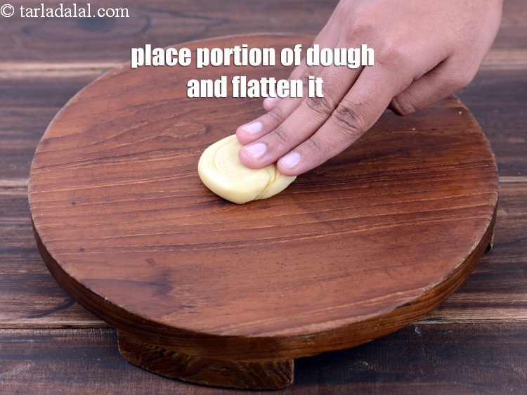 Step 42 – Place a portion of the dough on a clean, dry surface and flatten it slightly.