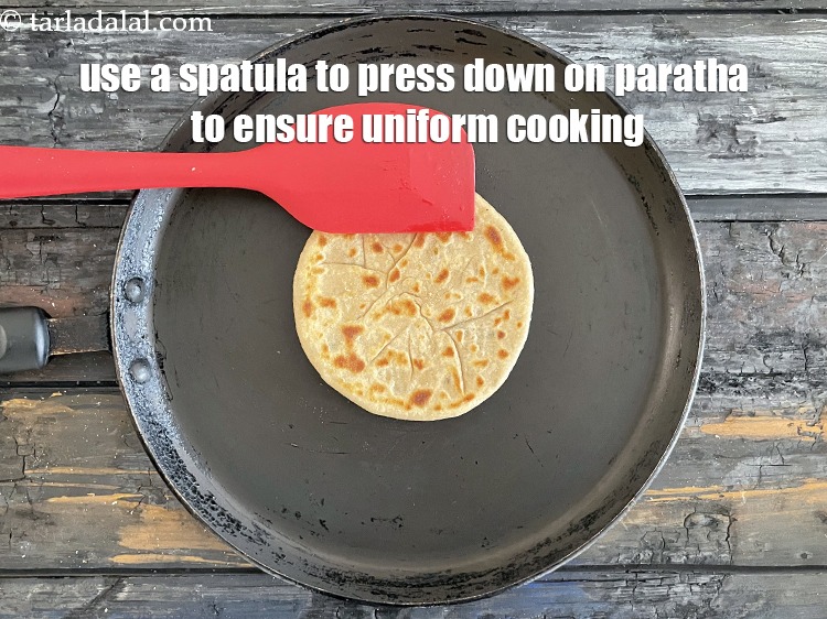 Step 46 – Always use a spaltula and press down while cooking the paratha. This must be done …