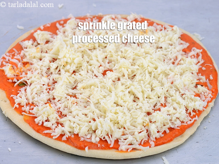 Step 42 – Sprinkle &frac12; cup of <a href="https://www.tarladalal.com/glossary-grated-processed-cheese-868i">grated processed cheese</a> evenly on it.&nbsp;