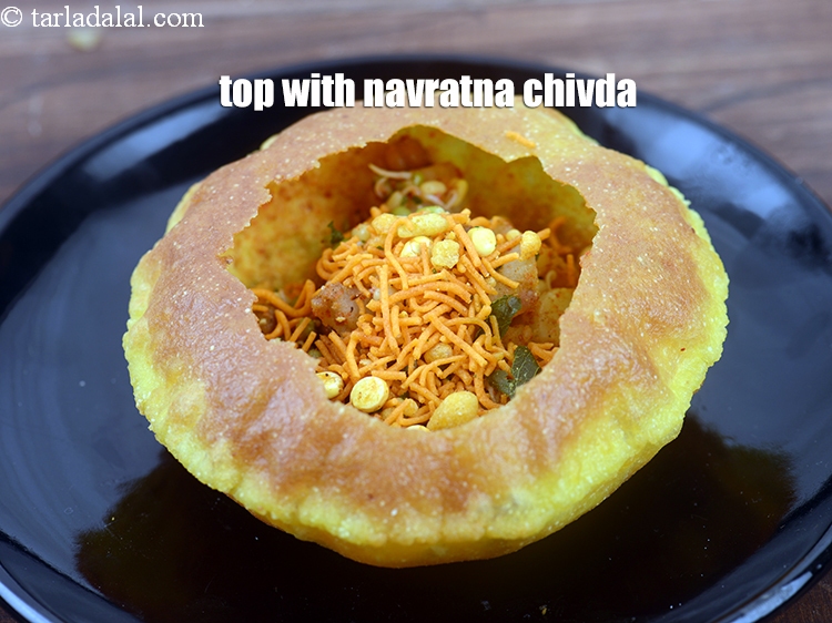 Step 44 – Top it with up 2 tbsp <a href="https://www.tarladalal.com/glossary-navratna-chivda-2810i">navratna chivda</a>.