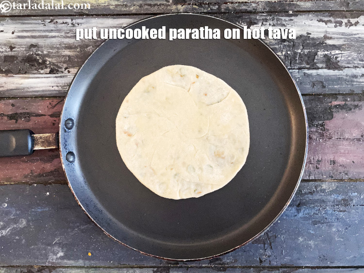 Step 39 – Heat a non-stick tava (griddle).&nbsp;Put rolled paratha on tava.&nbsp;