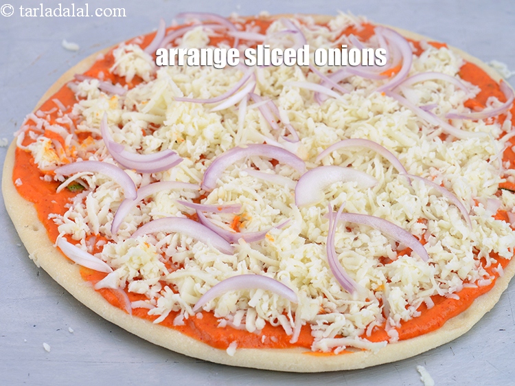 Step 43 – Arrange &frac14; cup <a href="https://www.tarladalal.com/glossary-sliced-onions-745i">sliced onions</a>.
