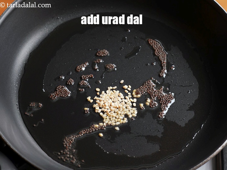Step 6 – When the seeds crackle, add &frac12; tsp <a href="https://www.tarladalal.com/glossary-urad-dal-split-black-lentil-941i">urad dal (split black lentils)</a>.