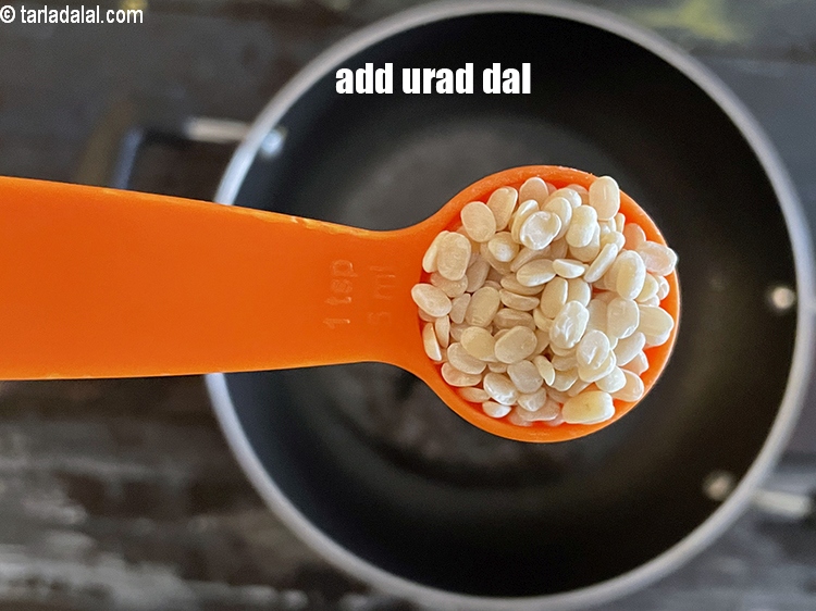 Step 16 – Add&nbsp;<meta charset="UTF-8" />1 tsp&nbsp;<a href="glossary-urad-dal-split-black-lentil-941i">urad dal (split black lentils)</a>.