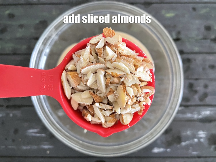 Step 13 – Add&nbsp;<meta charset="UTF-8" />1/4 cup&nbsp;sliced&nbsp;<a href="glossary-almonds-badam-378i">almonds (badam)</a>.