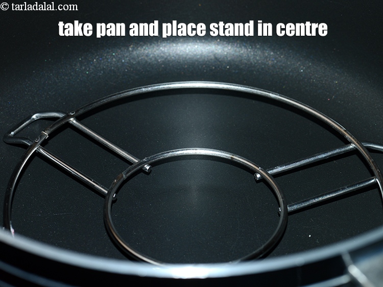 Step 7 – Take a deep pan and place a stand in the centre.