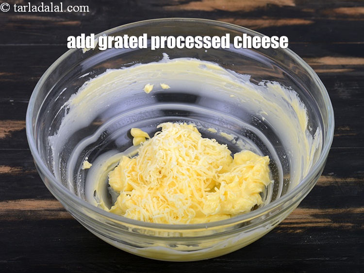 Step 5 – Add 2 tbsp <a href="https://www.tarladalal.com/glossary-grated-processed-cheese-868i">grated processed cheese</a>.