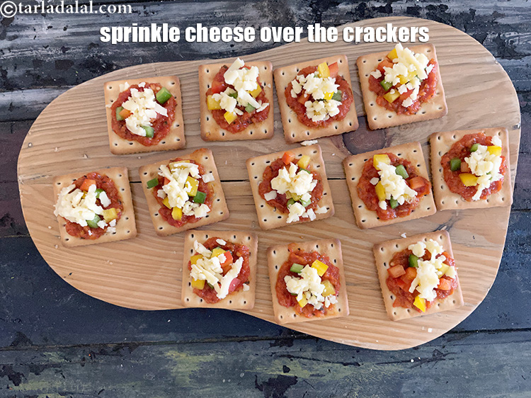 Step 9 – Sprinkle 1 tsp of cheese evenly over the cracker.