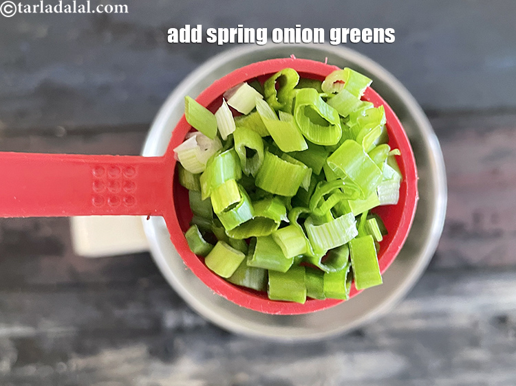 Step 9 – Add&nbsp;<meta charset="UTF-8" />1 1/2 tbsp&nbsp;finely&nbsp;<a href="glossary-chopped-spring-onion-greens-1030i">chopped spring onion greens</a>.