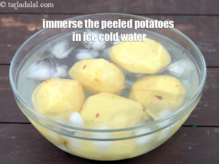 Step 7 – Immerse the peeled potatoes in ice cold water. This is to prevent them from disolouration.&nbsp;