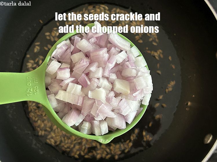 Step 7 – Let the seeds crackle and then add&nbsp;<meta charset="UTF-8" />1/2 cup&nbsp;<a href="glossary-chopped-onions-722i">chopped onions</a>.