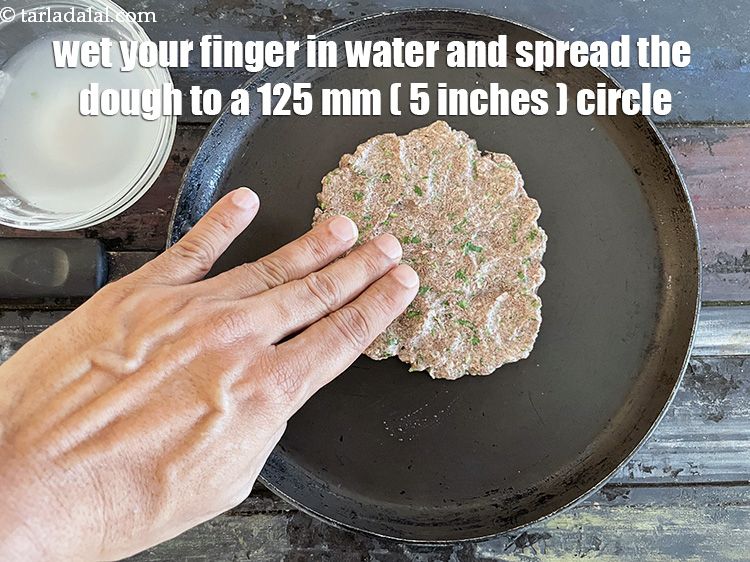 Step 18 – Wet your fingers and spread an even layer of one portion of the dough to …