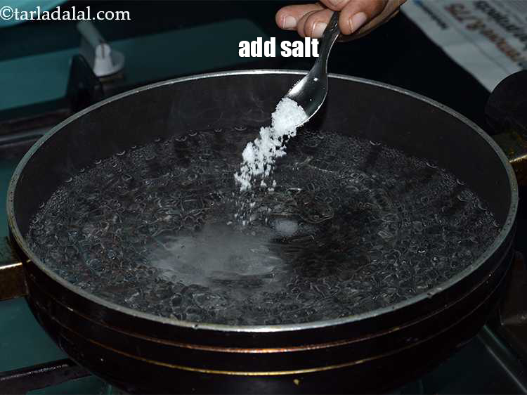 Step 5 – Once the water boils vigorously, add <a href="https://www.tarladalal.com/glossary-salt-namak-table-salt-418i">salt</a>. The salt will season the spaghetti as …