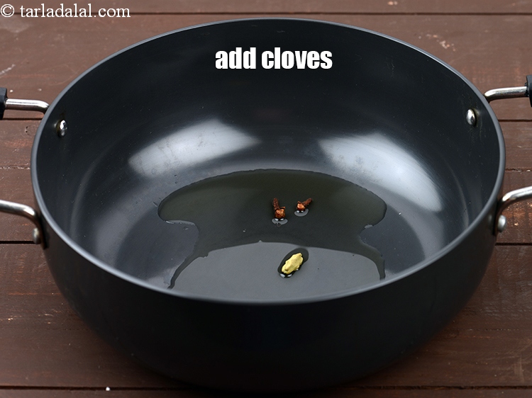 Step 6 – Add 2 <a href="https://www.tarladalal.com/glossary-cloves-laung-lavang-322i">cloves (laung / lavang)</a>.