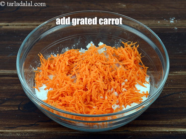 Step 5 – Add 1/2 cup <a href="https://www.tarladalal.com/glossary-grated-carrot-816i">grated carrot</a>.