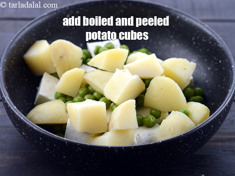 Step 5 – Add &frac12; cup <a href="https://www.tarladalal.com/glossary-boiled-and-chopped-potatoes-1879i">boiled and peeled potato cubes</a>.