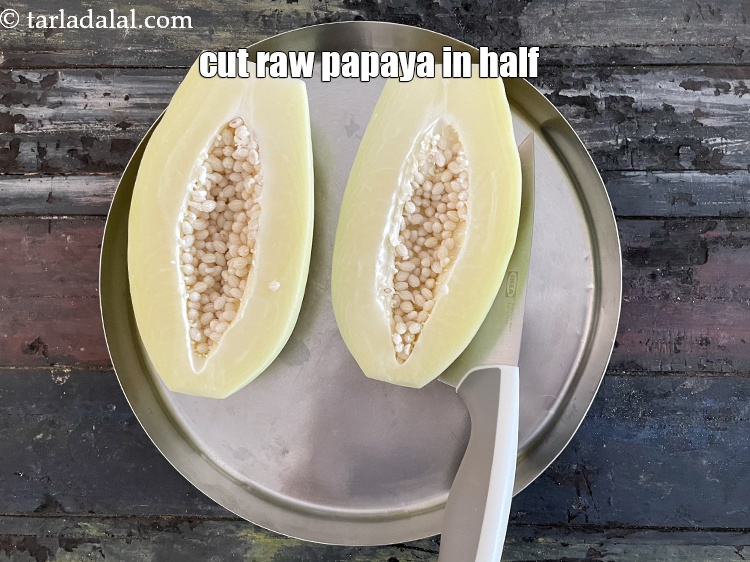 Step 5 – Cut the raw papaya in half.