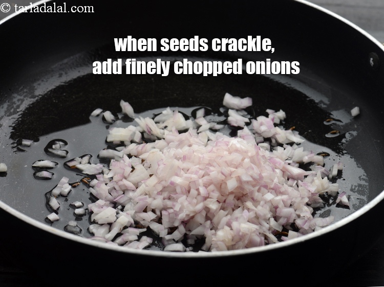 Step 5 – When the seeds crackle, add &frac12; cup finely&nbsp;<a href="https://www.tarladalal.com/glossary-chopped-onions-722i">chopped onions</a>.